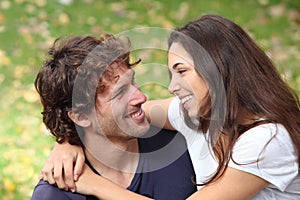 Couple cuddling and flirting in a park photo