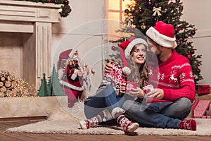 Couple with cups at christmastime
