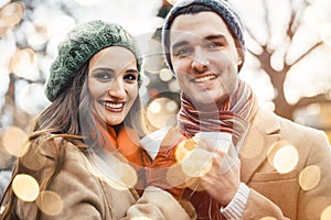 Couple with cups of mulled wine on Christmas market