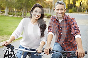 Couple On Cycle Ride In Countryside