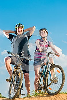 Couple of cyclists in helmets on bikes