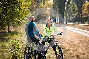 Couple of cyclists resting in park