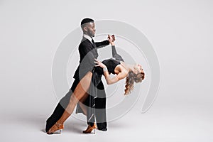 Couple dancers posing over white background. Dance school concept