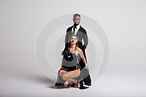 Couple dancers posing over white background. Dance school concept