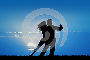 Couple dancig Tango at sunset