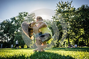 Couple dancing bachata in park backlit training dip figure
