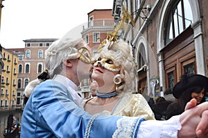 Couple dancing dressed up for Venice Carnival wearing contemporary clothes