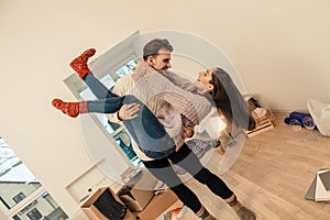 Couple dancing and having much fun while celebrating moving in