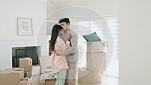 Couple, dancing and kiss to celebrate new home or moving in together with real estate property. A happy man and woman