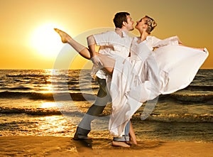 Couple dancing tango on the beach