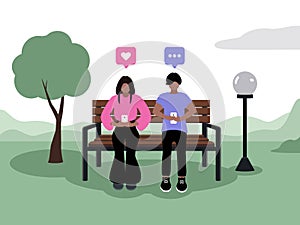 Couple with dark skin sitting in phones in the park