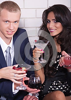 Couple on date in bar or night club enjoying wine