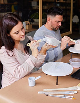 Couple, date and painting ceramics for creativity, art workshop for bonding with paintbrush and material. Anniversary