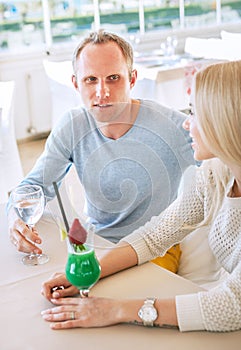 Couple dating moment in cozy sunny restaurant