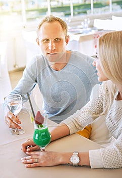 Couple dating moment in cozy sunny restaurant