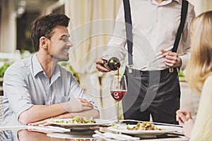 Couple Dating in Restaurant and Drinking Red Wine.