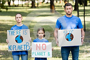 Couple with daughter holding placards with