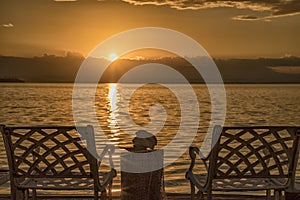 A couple of deck chairs at sunrise