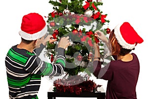 Couple decorate Christmas tree photo