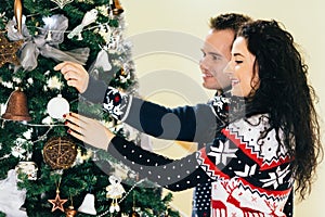 Couple decorating christmas tree