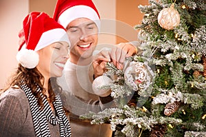 Couple Decorating Christmas Tree photo