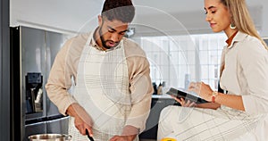 Couple, digital tablet and cooking with online recipe on the kitchen. Young man cutting vegetables and woman reading