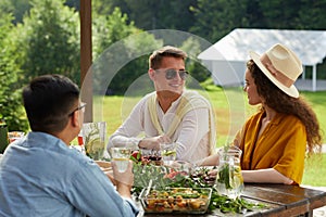 Couple Dining Outdoors at Summer Party