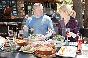 Couple dining in restaurant in open air