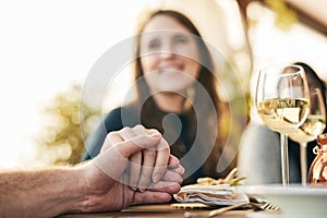 Couple, dinner and holding hands to celebrate love, support and marriage together outdoor. Romance date, woman and lunch