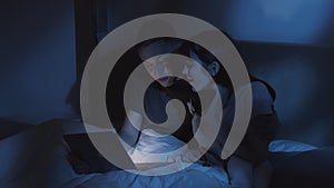 couple disagreement night quarrel laptop in bed