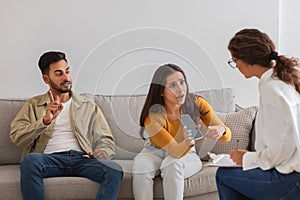 Couple in a disagreement, professional mediating at counselor office