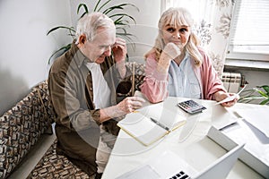 Couple discussing bills at home