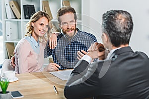 Couple discussing contract with lawyer