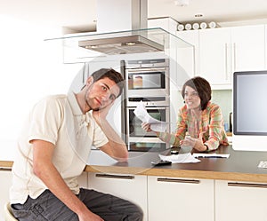 Couple Discussing Personal Finances In Kitchen photo