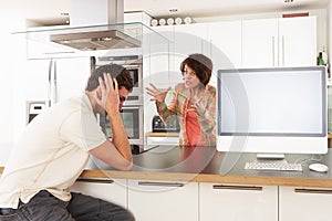 Couple Discussing Personal Finances In Kitchen