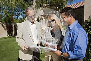 Couple In Discussion With Real Estate Agent