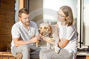 Couple with dog on the backyard