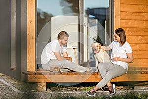 Couple with dog on the backyard of their house