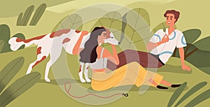 Couple and dog relaxing in nature on summer holidays. Happy man and woman resting outdoors with doggy. People sitting on