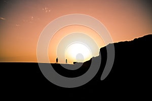 Couple with dog walking during sunset