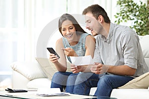 Couple doing accounting with a phone bank app photo