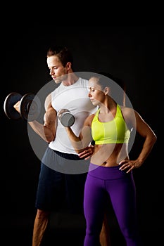 Couple doing dumbbell lifts