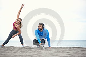 Couple doing exercises on the beach