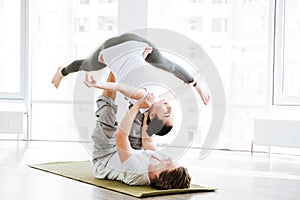 Couple doing flexibility workout in yoga studio