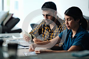 Couple Doing Home Budget Counting Money To Pay Bills