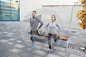 Couple doing lunge exercise on city street