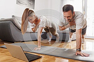 Couple doing online yoga course