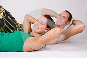 Couple doing sit ups