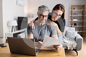 Couple Doing Taxes And Family Budget