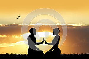 Couple doing yoga at sunset